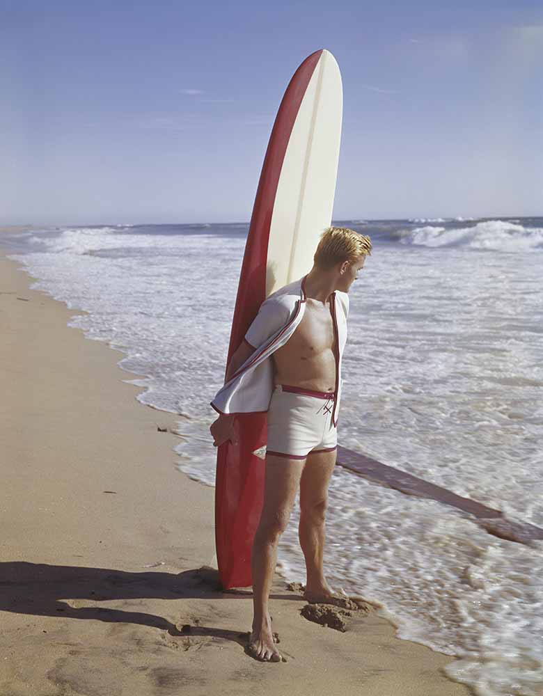Surfer holding surfboard on beach fine art photography