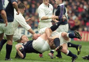 Duncan Hodge of Scotland is tackled by Neil Back of England