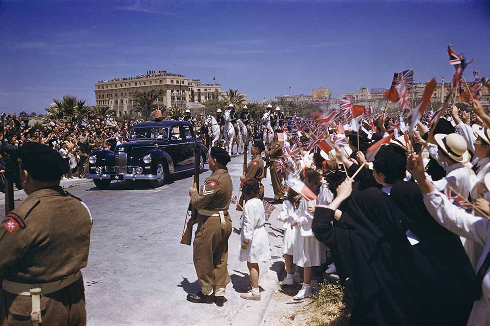 1954. Royal Tour to Malta. Queen Elizabeth II and Prince Philip, the Duke of Edinburgh, are pictured in a Land Rover acknowledging the cheers of Maltese schoolchildren at a rally on the Floriana Granaires. fine art photography