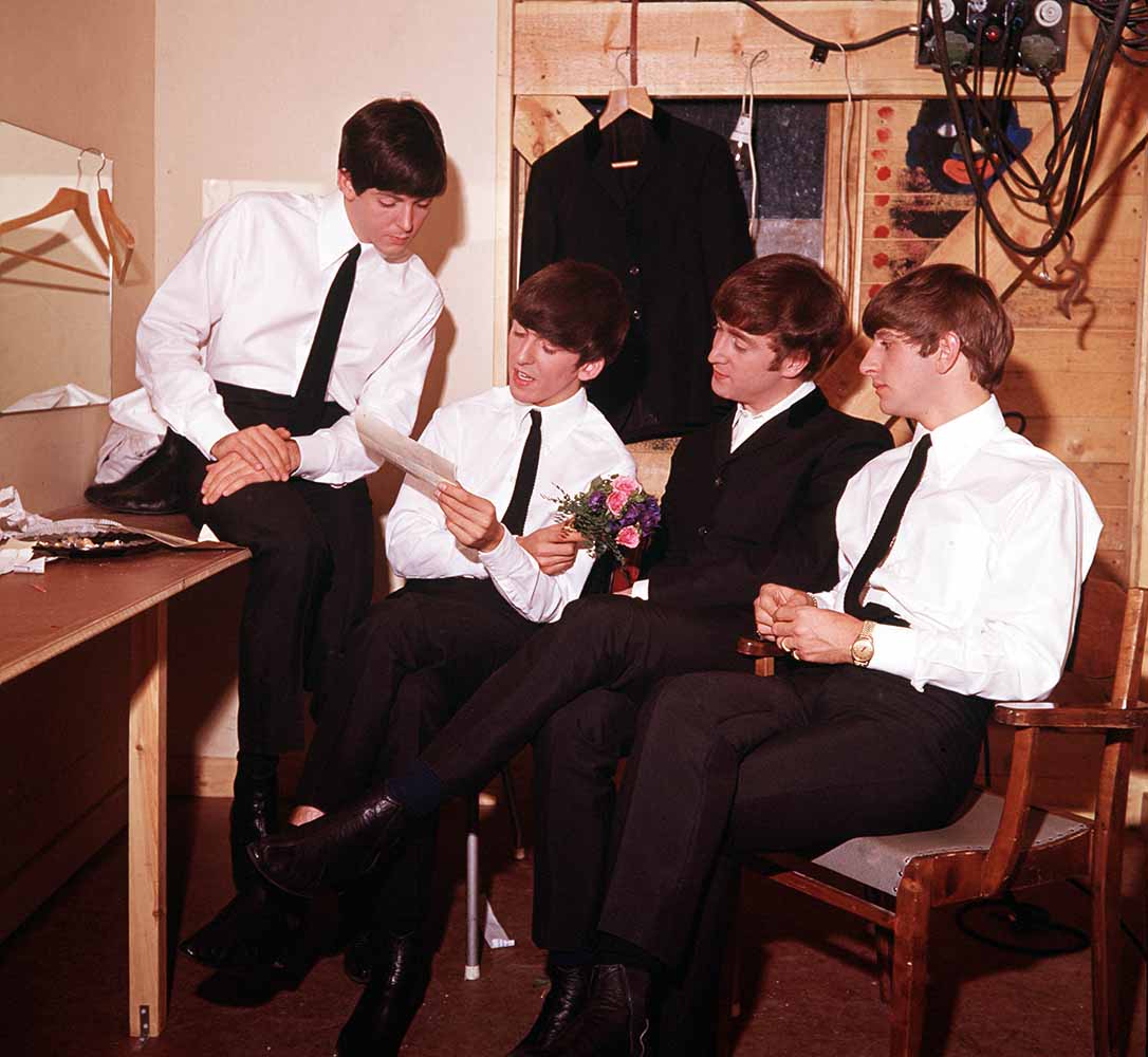 Volume 2. Page 85, Picture 8. 1963. The pop group “The Beatles” read a letter in their dressing room. Pictured left to right: Paul McCartney, George Harrison, John Lennon and Ringo Starr. fine art photography