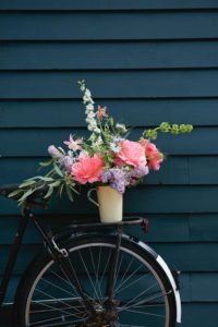 An arrangement of flowers on the back of a bicycle