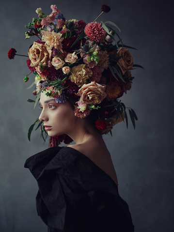 Thoughtful young woman in floral headdress fine art photography