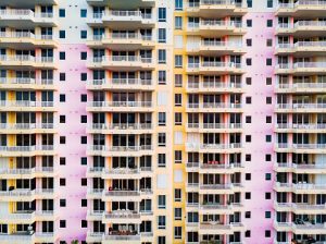 Drone view of colorful building in Miami with balcony levels.
