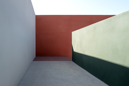Corridor composed of colored concrete walls, with sunlight effect fine art photography