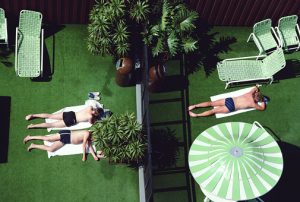 People sunbathing on artificial grass, overhead view