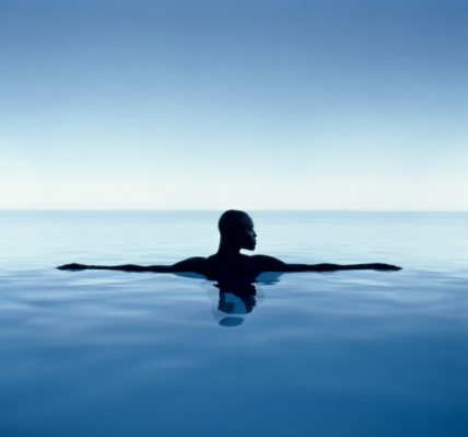 Man with arms outreached floating in sea fine art photography