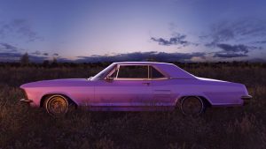 Pink 1970s American Classic Car in a Field at Sunset
