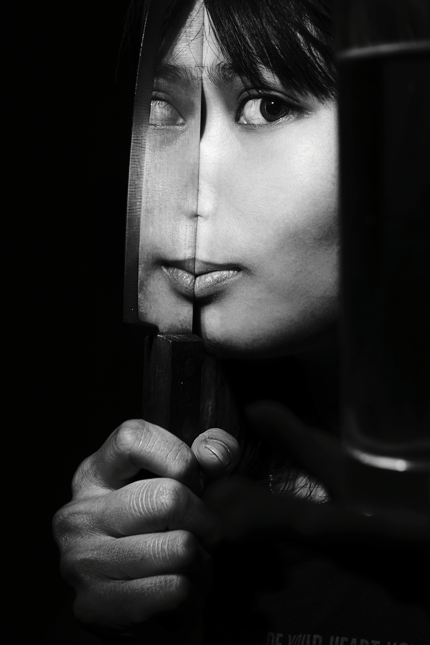 Portrait Of Woman Holding Kitchen Knife With Reflection Against Black Background fine art photography