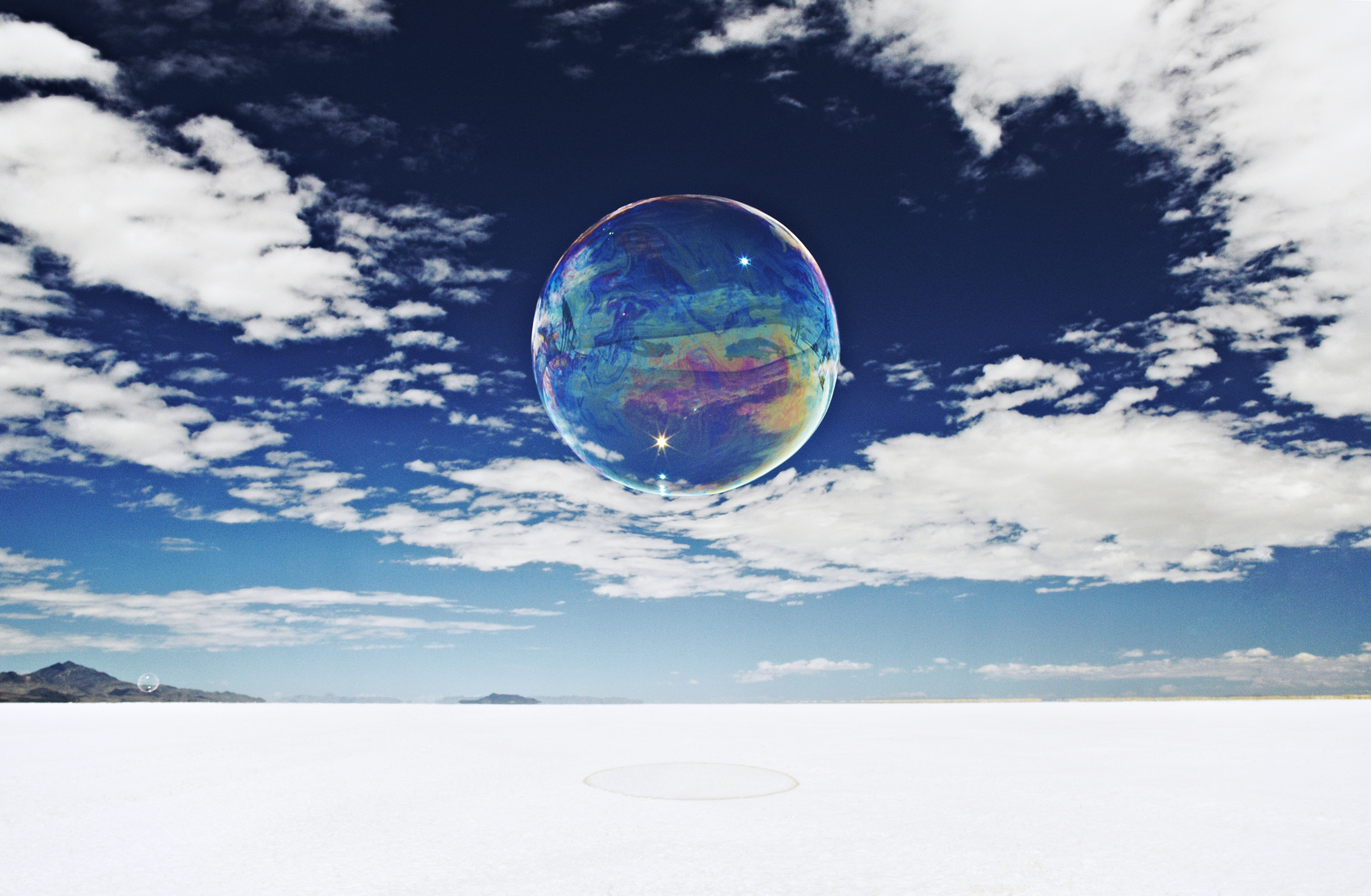 Large, round bubble floating above salt flats. fine art photography