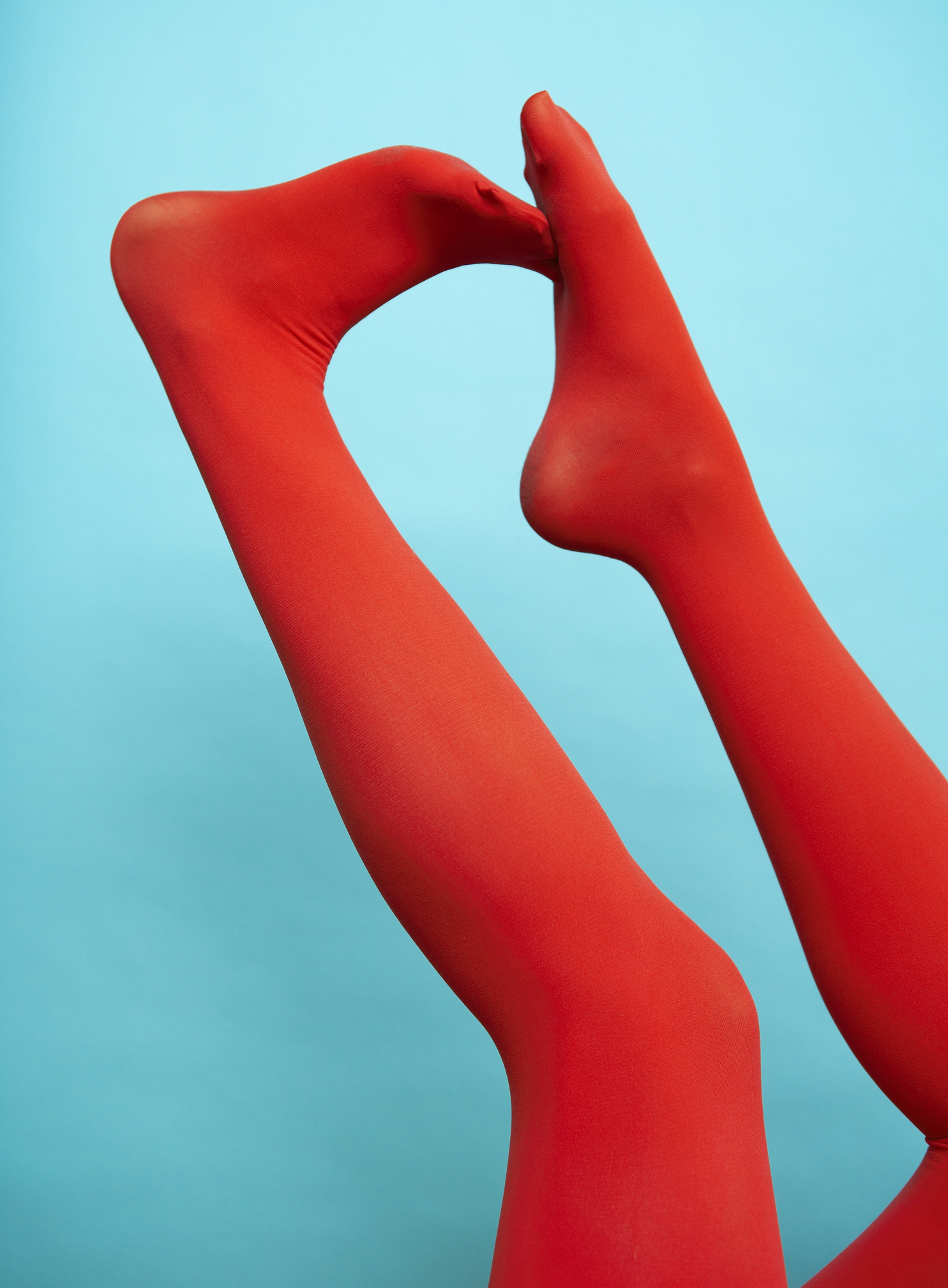 Person wearing red legging, low section, close-up fine art photography